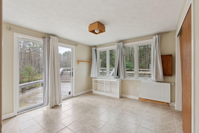 12 Bufflehead Cove Ln, Kennebunk, ME 04043 - empty room with baseboards, radiator heating unit, and light tile patterned flooring