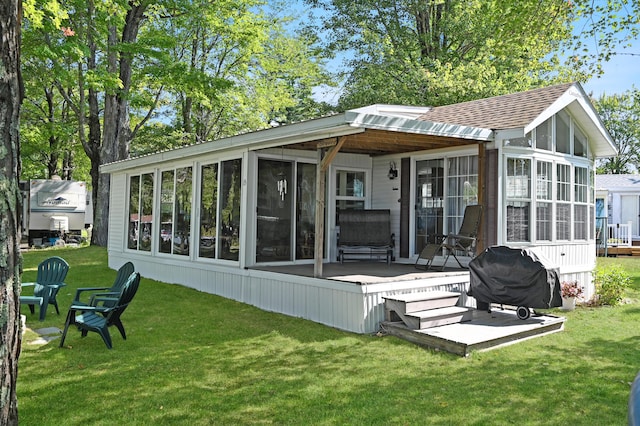 15 Allens Way Unit 18, Raymond, ME 04071 - rear view of house featuring a sunroom, a yard, a shingled roof, and a deck