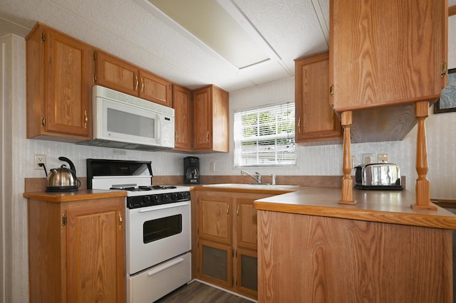 15 Allens Way Unit 18, Raymond, ME 04071 - kitchen featuring a sink, light countertops, white appliances, and brown cabinets