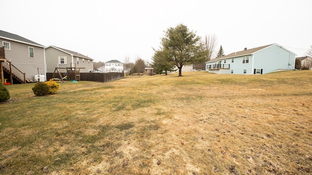 view of yard featuring a wooden deck, a residential view, and stairway