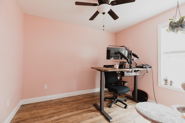 office area featuring wood finished floors, ceiling fan, and baseboards