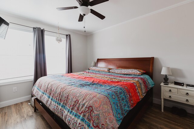 bedroom featuring baseboards, crown molding, a ceiling fan, and wood finished floors