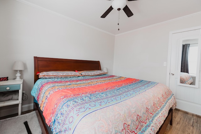 bedroom with ornamental molding, ceiling fan, and wood finished floors