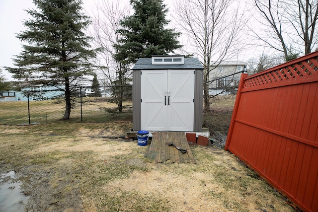 view of shed featuring fence