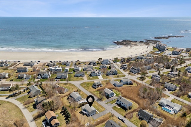 bird's eye view featuring a water view, a view of the beach, and a residential view