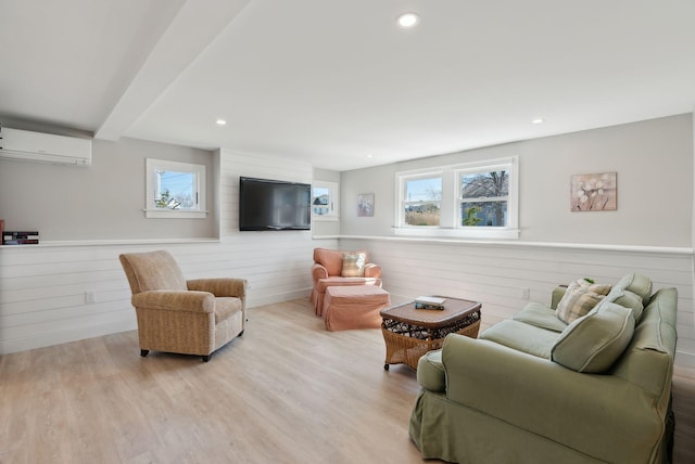 living room featuring wood finished floors, wood walls, a wall mounted AC, and a wainscoted wall