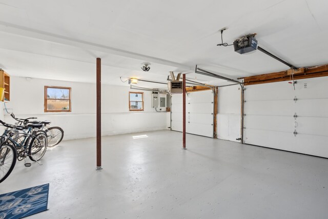 garage with a garage door opener and electric panel