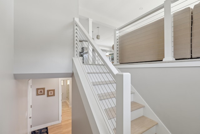 stairway with baseboards and wood finished floors