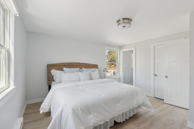 bedroom with baseboards and light wood-type flooring