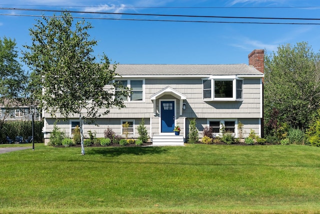 36 Surf Ln, Kennebunk, ME 04043 - split foyer home with a chimney, a front lawn, and entry steps
