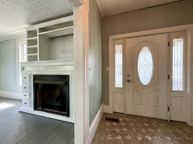 68 Washington St, Eastport, ME 04631 - entrance foyer featuring baseboards, a fireplace, and ornamental molding