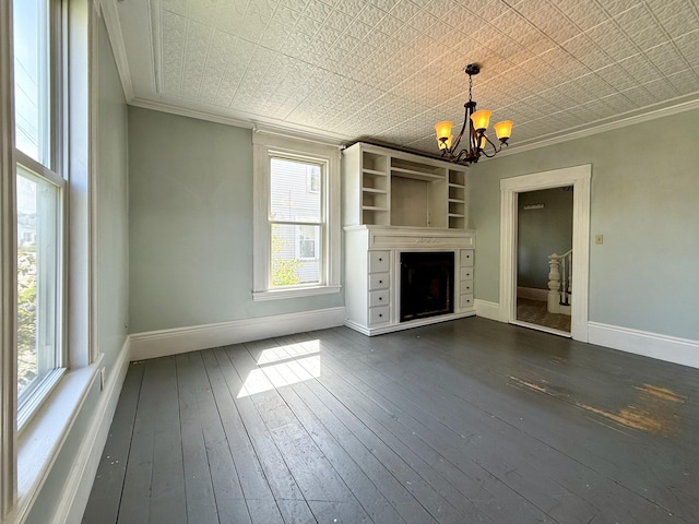 68 Washington St, Eastport, ME 04631 - unfurnished living room featuring a chandelier, crown molding, plenty of natural light, baseboards, and a fireplace