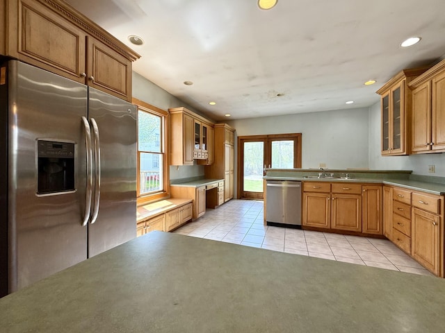 68 Washington St, Eastport, ME 04631 - kitchen with stainless steel appliances, plenty of natural light, light tile patterned floors, glass insert cabinets, and recessed lighting