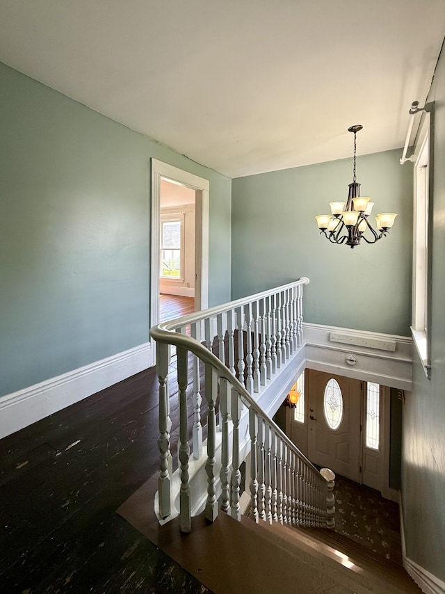 68 Washington St, Eastport, ME 04631 - staircase with a chandelier, wood finished floors, and baseboards