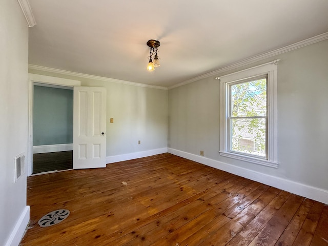 68 Washington St, Eastport, ME 04631 - spare room featuring hardwood / wood-style flooring, crown molding, and baseboards