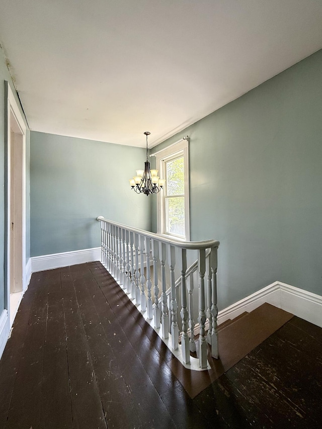 68 Washington St, Eastport, ME 04631 - hall with hardwood / wood-style flooring, a chandelier, an upstairs landing, and baseboards