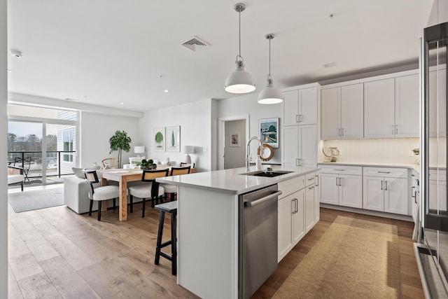 267 US Route 1 Ph 508, Falmouth, ME 04105 - kitchen featuring stainless steel dishwasher, visible vents, wood finished floors, a sink, and backsplash