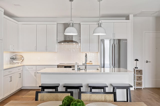 267 US Route 1 Ph 508, Falmouth, ME 04105 - kitchen featuring high end fridge, light countertops, white cabinetry, visible vents, and wall chimney exhaust hood
