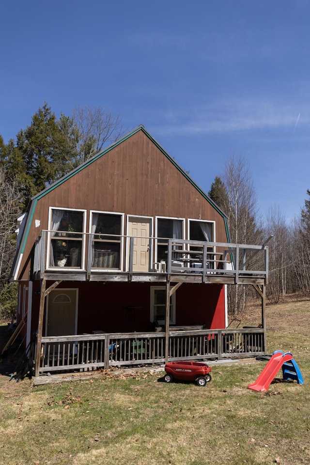 exterior space featuring a lawn and a deck