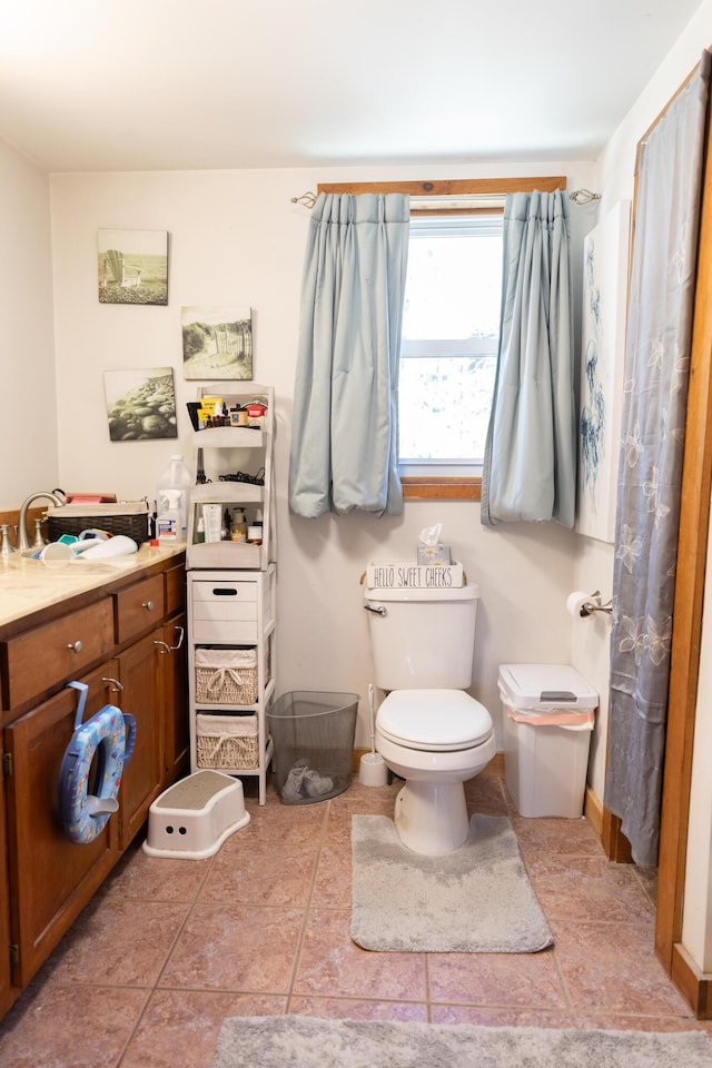 full bath with toilet, tile patterned floors, and a sink