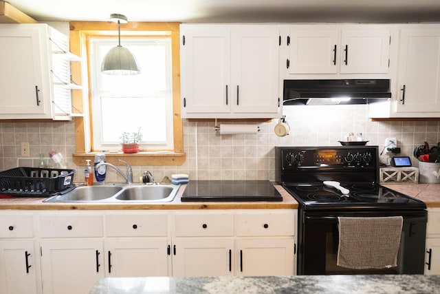 kitchen with under cabinet range hood, a sink, white cabinetry, and black appliances