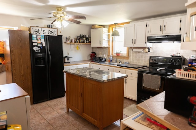 kitchen featuring a sink, tasteful backsplash, a ceiling fan, under cabinet range hood, and black appliances