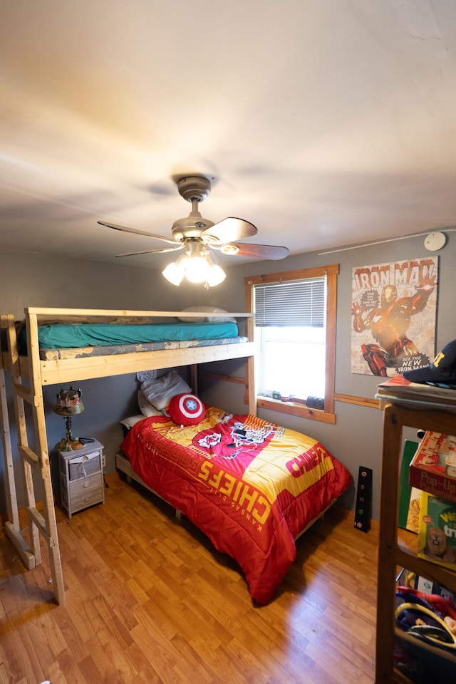 bedroom with a ceiling fan and wood finished floors