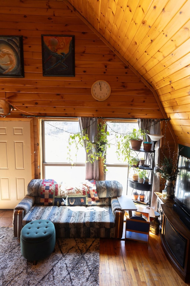living room featuring high vaulted ceiling, wooden ceiling, hardwood / wood-style flooring, and wooden walls