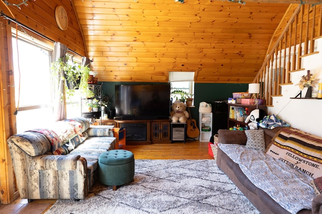 living area featuring lofted ceiling, wood finished floors, stairs, and wood ceiling