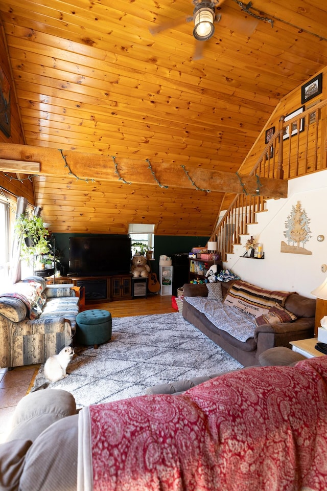 living room with lofted ceiling, a ceiling fan, wood finished floors, stairway, and wood ceiling