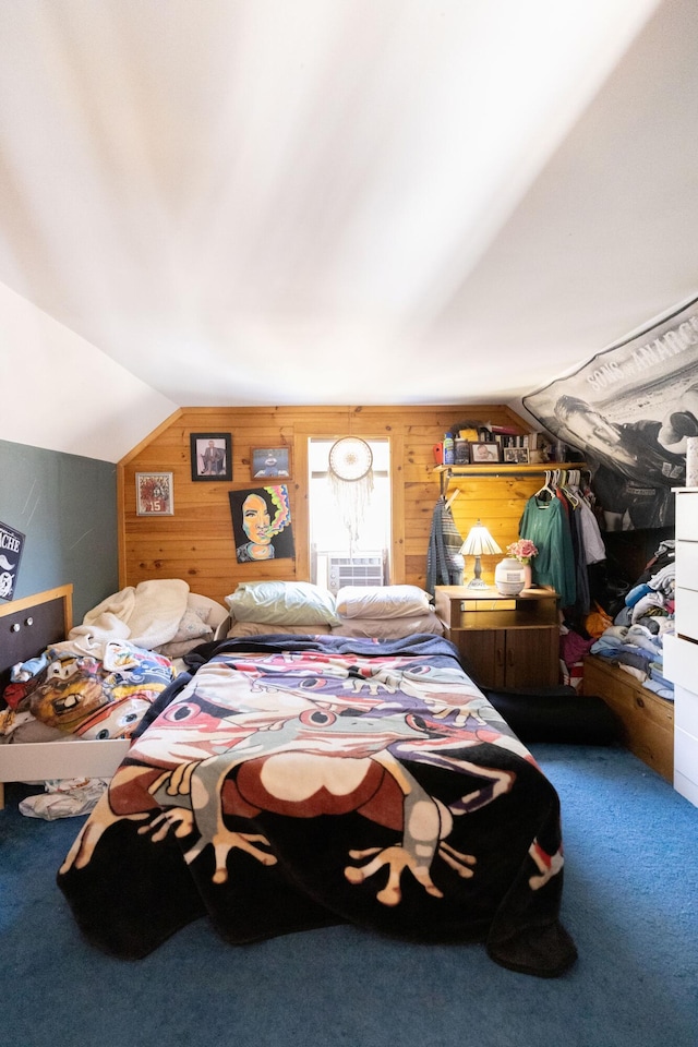 bedroom with wooden walls, lofted ceiling, and carpet flooring