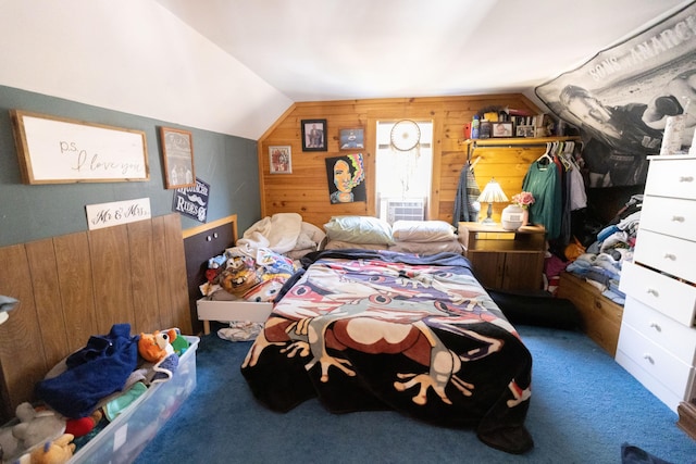 bedroom with wooden walls, lofted ceiling, and carpet flooring