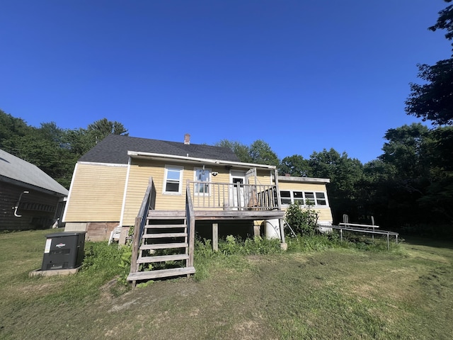 113 River Rd, Dresden, ME 04342 - back of property featuring a deck, a chimney, a yard, and stairway