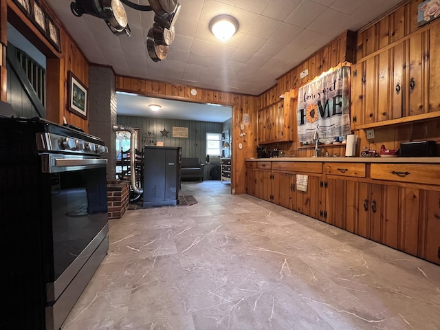 113 River Rd, Dresden, ME 04342 - kitchen featuring brown cabinets, wood walls, stainless steel range, and light countertops