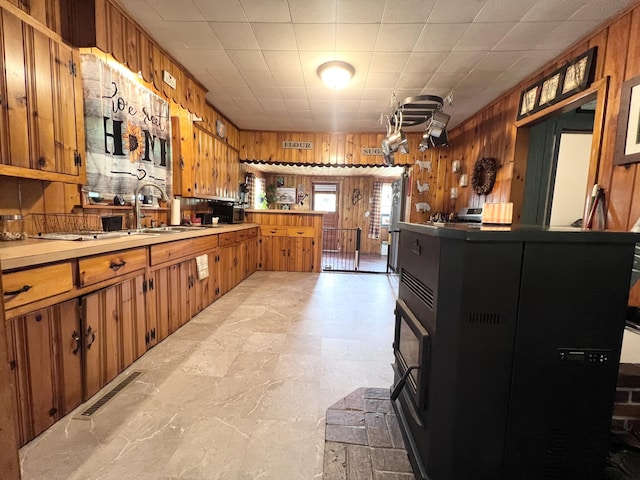 113 River Rd, Dresden, ME 04342 - kitchen with wooden walls, brown cabinets, and light countertops