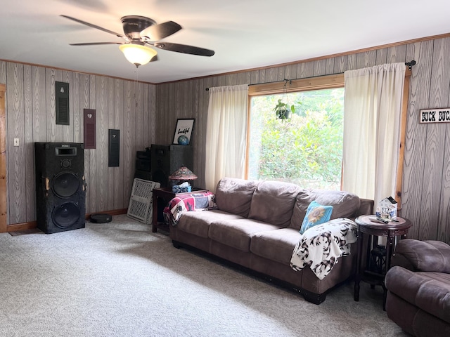 113 River Rd, Dresden, ME 04342 - carpeted living room with wood walls, ceiling fan, and crown molding