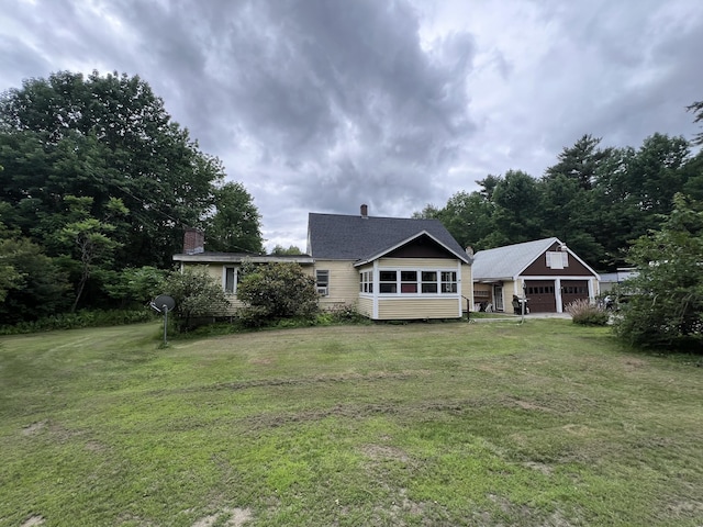 113 River Rd, Dresden, ME 04342 - back of house with a garage, an outdoor structure, a yard, and a chimney