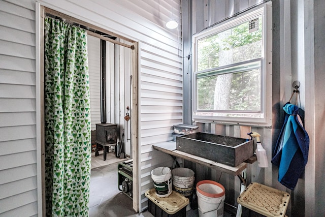 interior space with a wood stove and concrete flooring