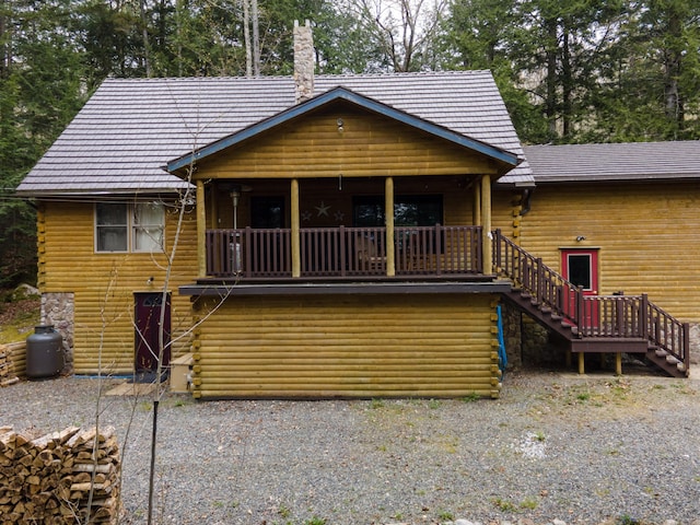 5 Canoe Ct Unit T3 R9, Nwp, ME 04462 - back of property featuring stairs, log exterior, a chimney, and covered porch