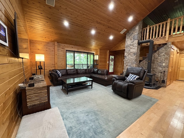 5 Canoe Ct Unit T3 R9, Nwp, ME 04462 - living room featuring a wood stove, hardwood / wood-style flooring, recessed lighting, high vaulted ceiling, and wooden walls