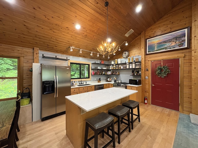 5 Canoe Ct Unit T3 R9, Nwp, ME 04462 - kitchen with stainless steel appliances, open shelves, light wood finished floors, healthy amount of natural light, and wood walls