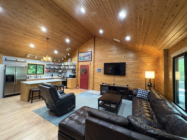 5 Canoe Ct Unit T3 R9, Nwp, ME 04462 - living area featuring wood ceiling, vaulted ceiling, a chandelier, wooden walls, and plenty of natural light