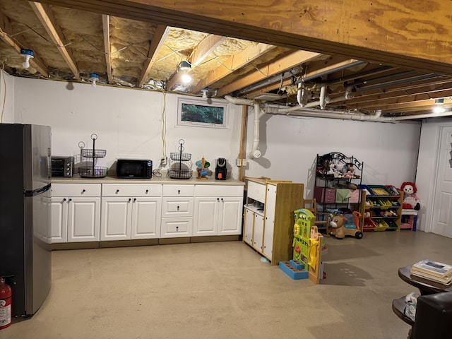 5 Canoe Ct Unit T3 R9, Nwp, ME 04462 - unfinished below grade area with freestanding refrigerator