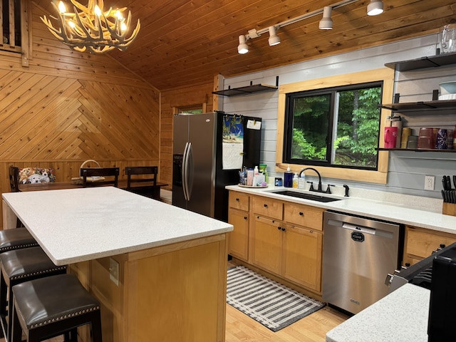 5 Canoe Ct Unit T3 R9, Nwp, ME 04462 - kitchen with stainless steel appliances, a chandelier, wood walls, rail lighting, and light countertops