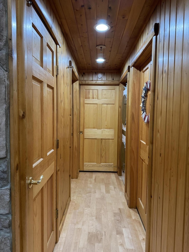 5 Canoe Ct Unit T3 R9, Nwp, ME 04462 - hall with stacked washer / dryer, wood walls, light wood-style flooring, and wood ceiling