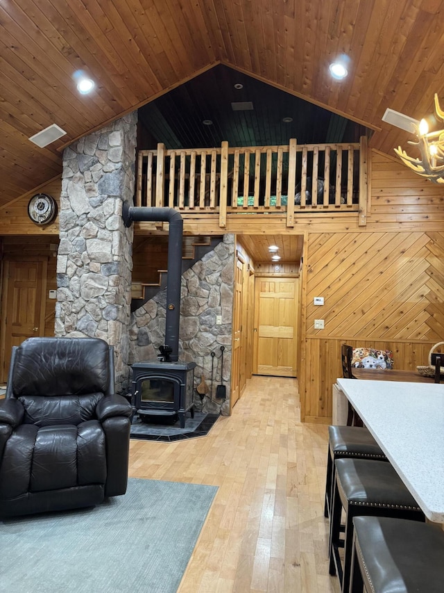 5 Canoe Ct Unit T3 R9, Nwp, ME 04462 - living room with a wood stove, light wood-type flooring, wooden ceiling, wooden walls, and high vaulted ceiling
