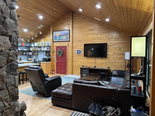 5 Canoe Ct Unit T3 R9, Nwp, ME 04462 - living room with high vaulted ceiling, light wood-style flooring, wood ceiling, wooden walls, and bar