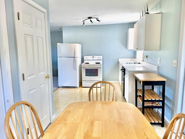 18 Hampton Ave, Old Orchard Beach, ME 04064 - kitchen featuring white appliances, baseboards, white cabinetry, a sink, and light tile patterned floors