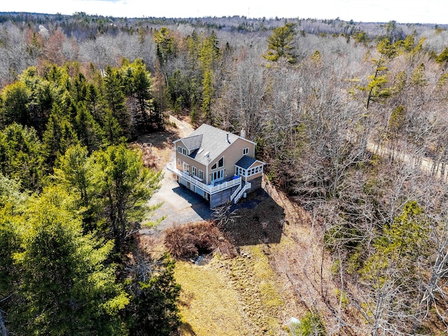 drone / aerial view with a wooded view