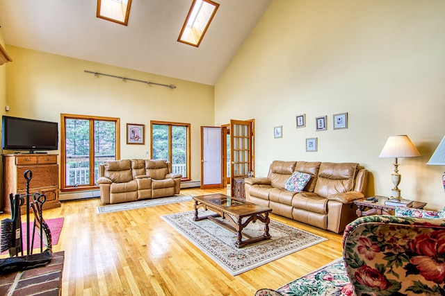 living room with a skylight, high vaulted ceiling, baseboard heating, and wood finished floors